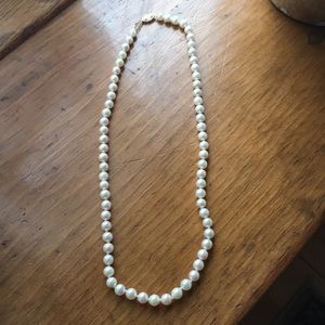 Genuine white pearls with 14 Kt clasp. 16 in